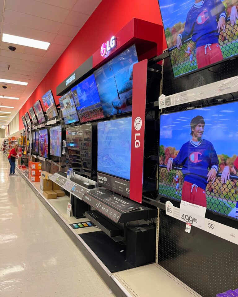 bank of big screen tvs at the store.