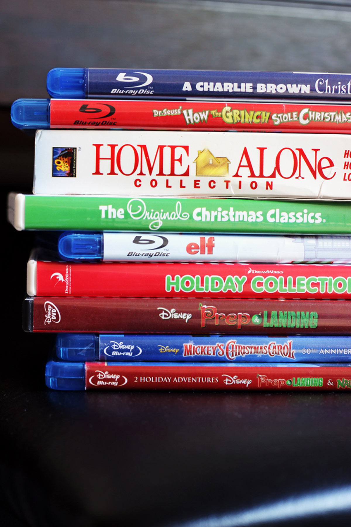 stack of christmas movie dvds including home alone and elf.