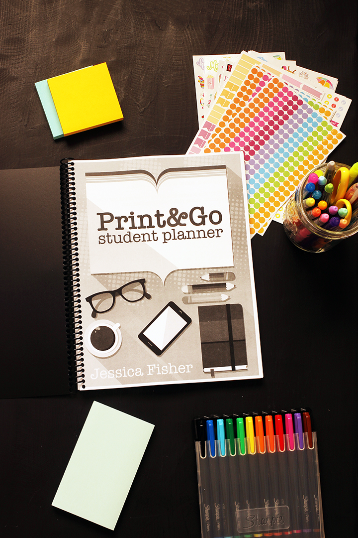 black and white student planner with pens stickers and post-its