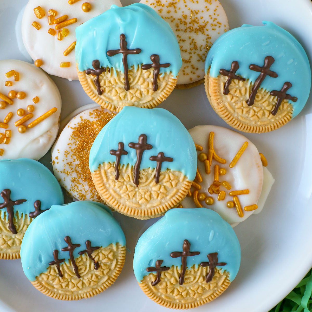 an array of chocolate dipped oreos, some with the crosses of calvary piped on them.