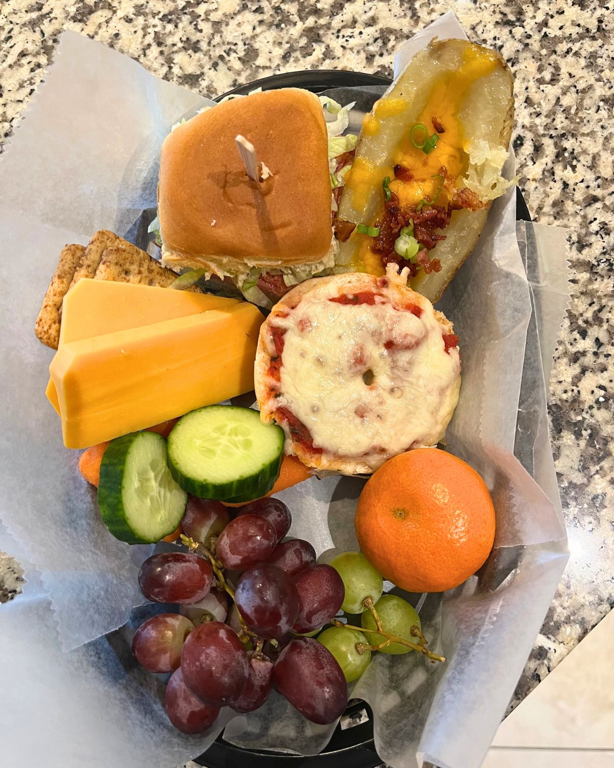 plastic basket filled with snacky dinner items.