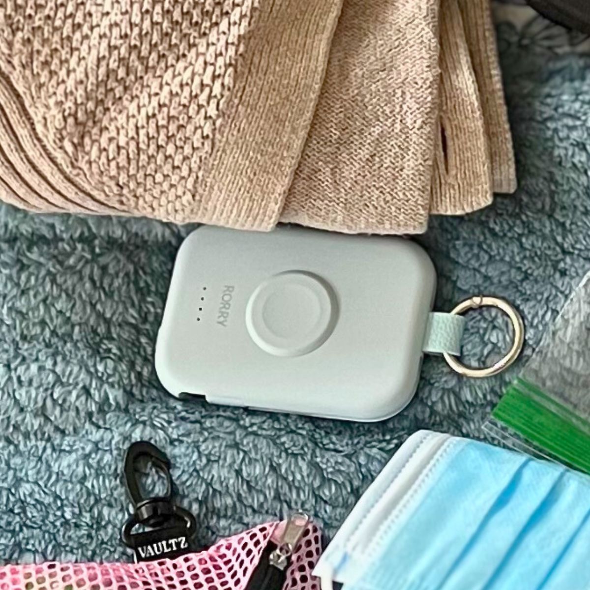 Rorry battery charger on bed with other items to pack.