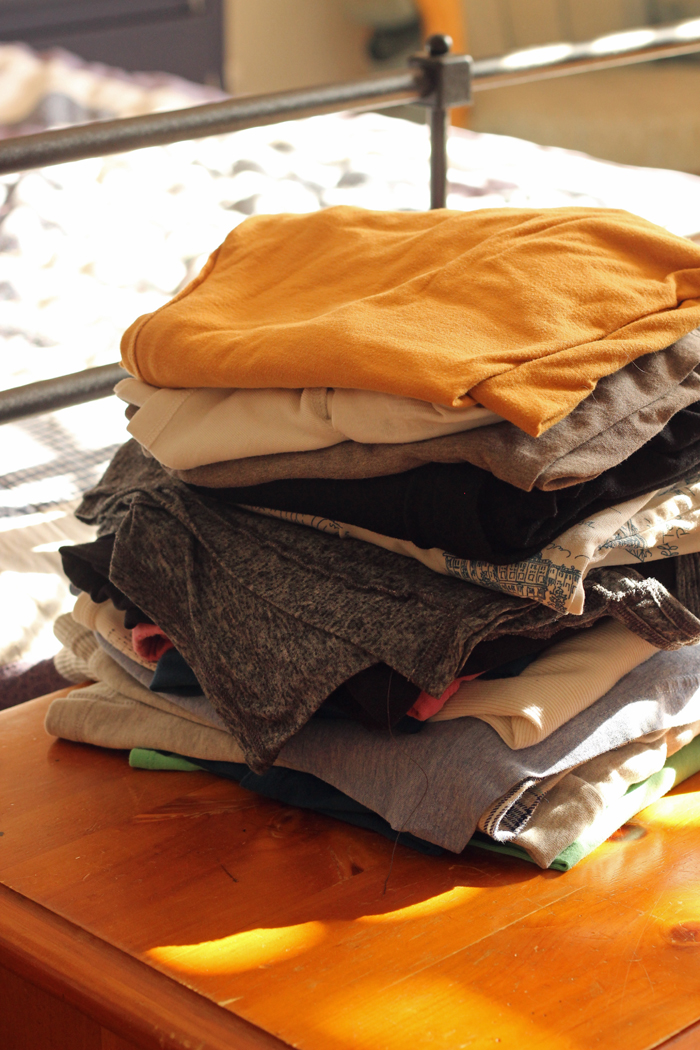 stack of clean folded clothes on chest