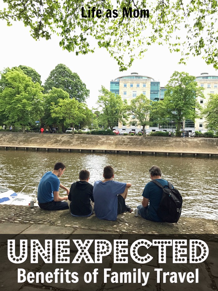 Dad and sons sitting next to a body of water in York.