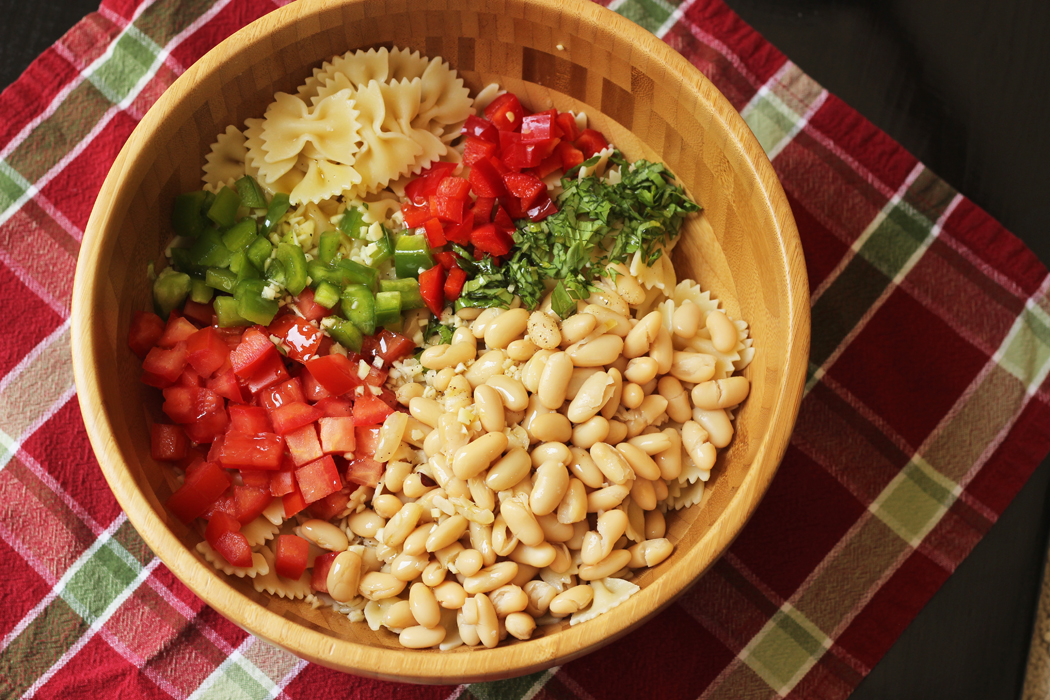 A bowl of bowtie pasta salad ingredients 