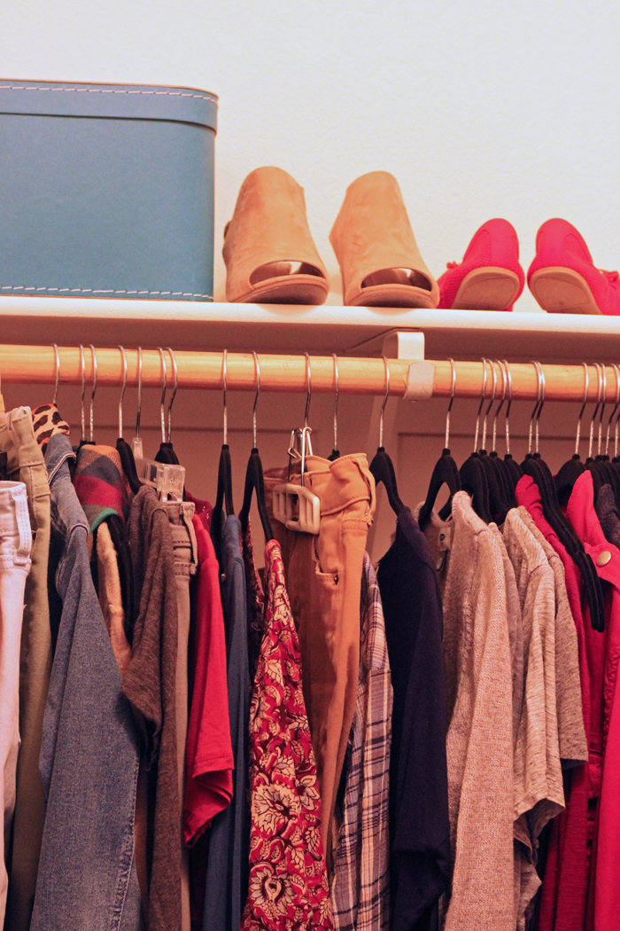 clothes on hangers and shoes on shelf