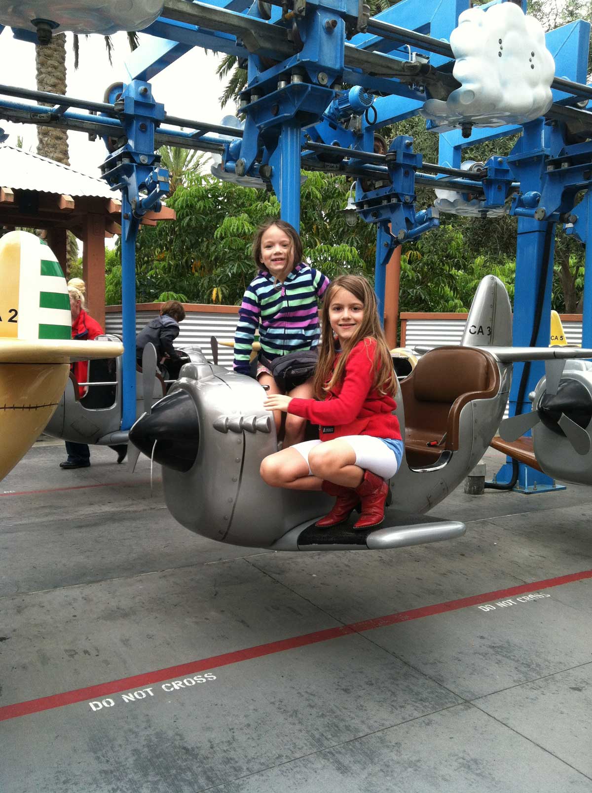 girls climbing into airplane ride at legoland.