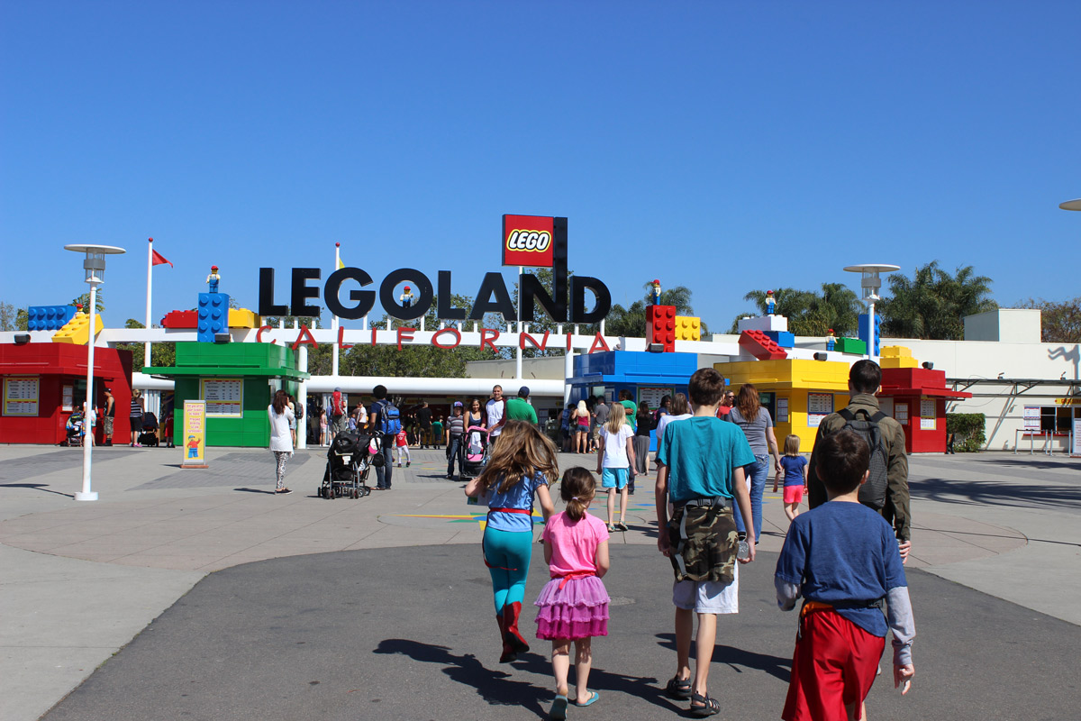 groups of people walking toward entrance of legoland california.