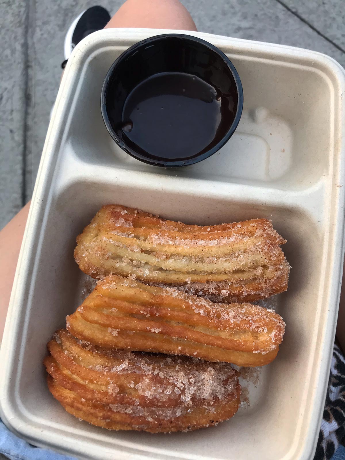 churros and chocolate sauce in box.