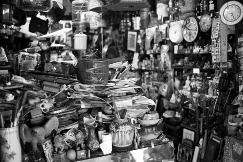 black and white photo of a cluttered room.