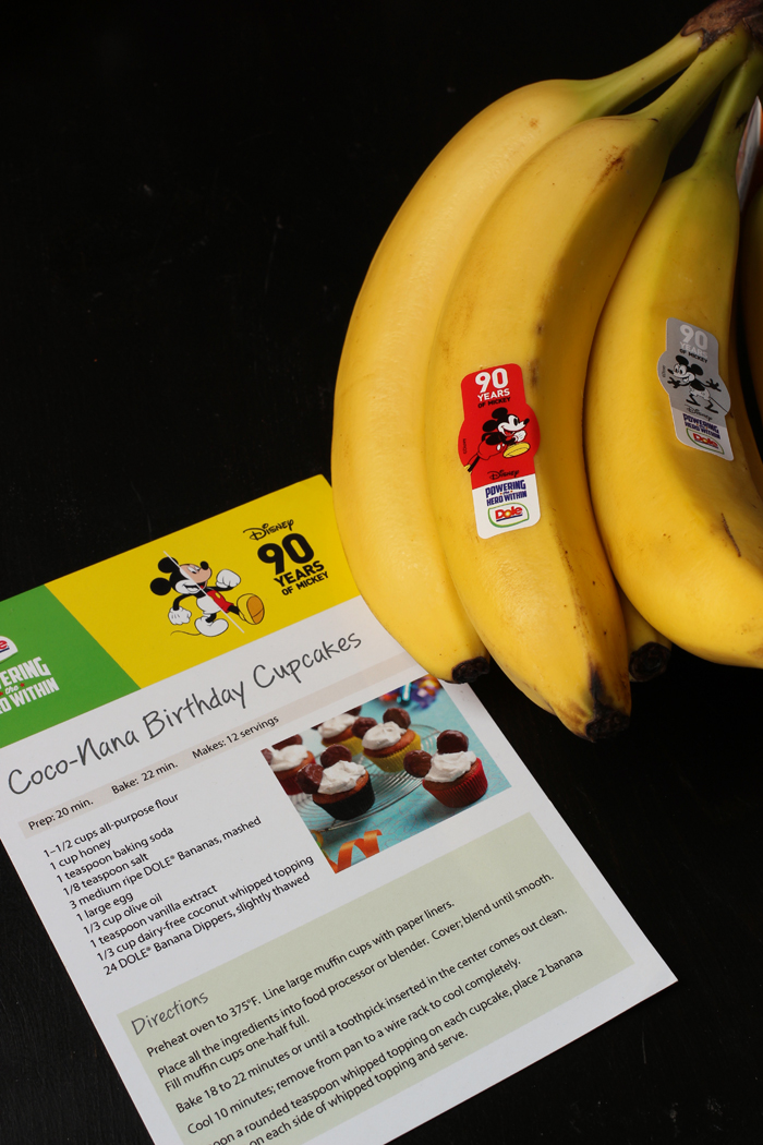 A banana sitting on top of a table with cupcake recipe.