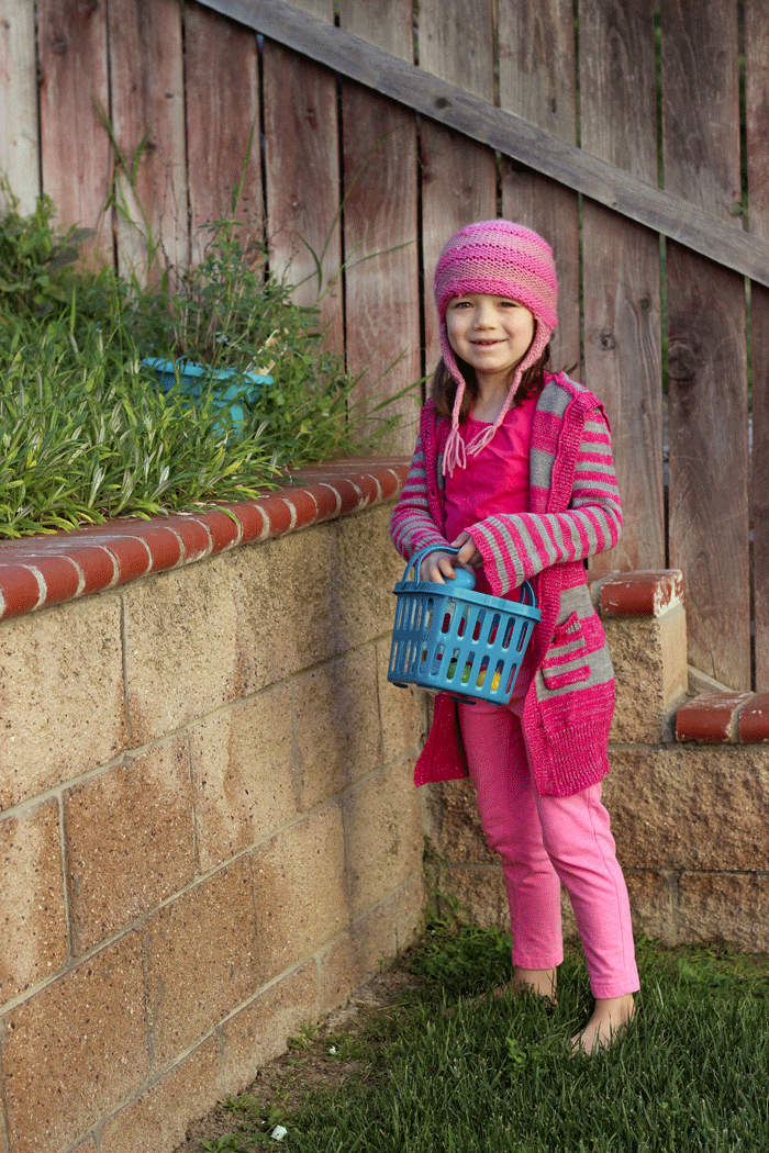 girl collecting easter eggs in basket