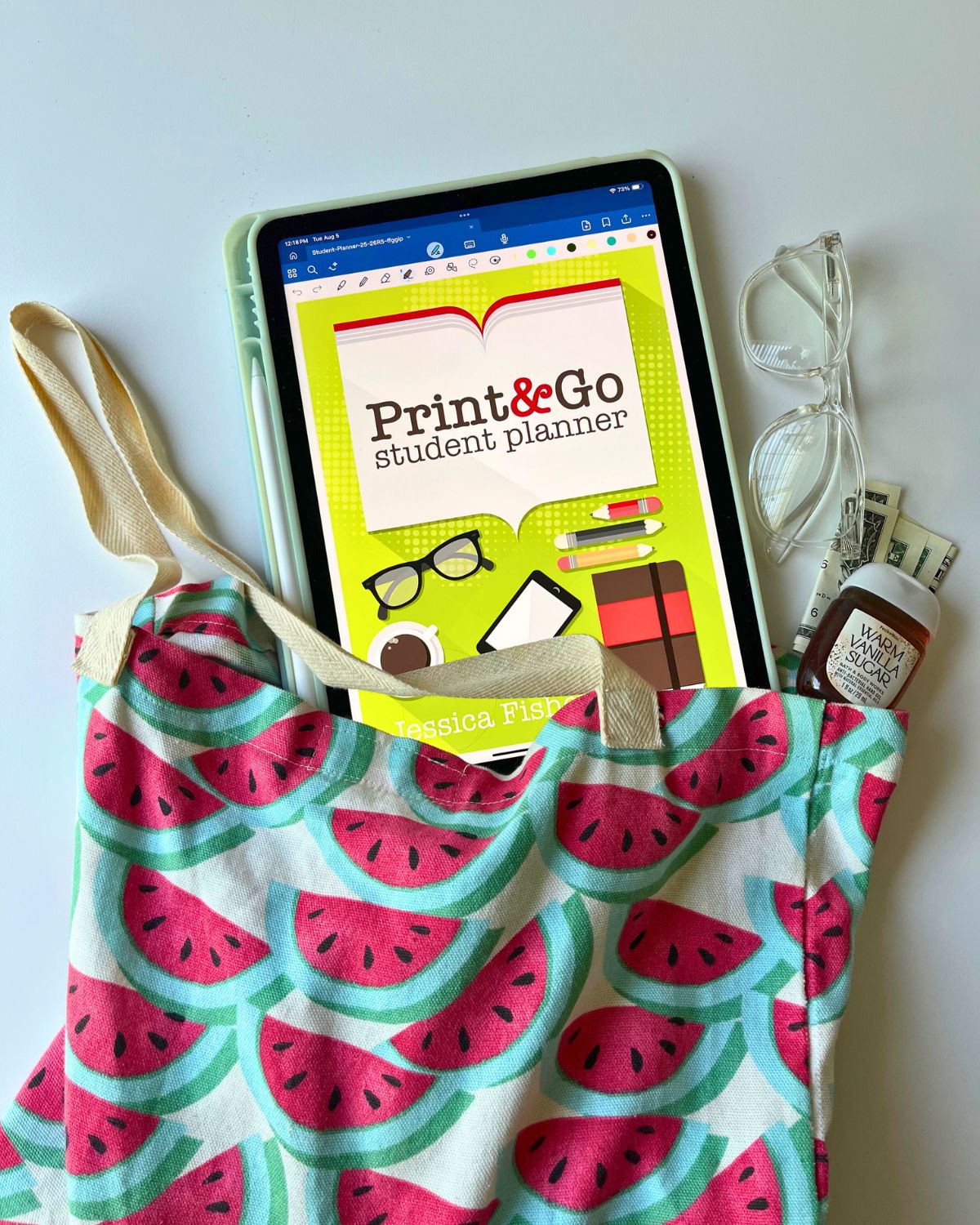 student planner on iPad peeking out of watermelon tote bag.