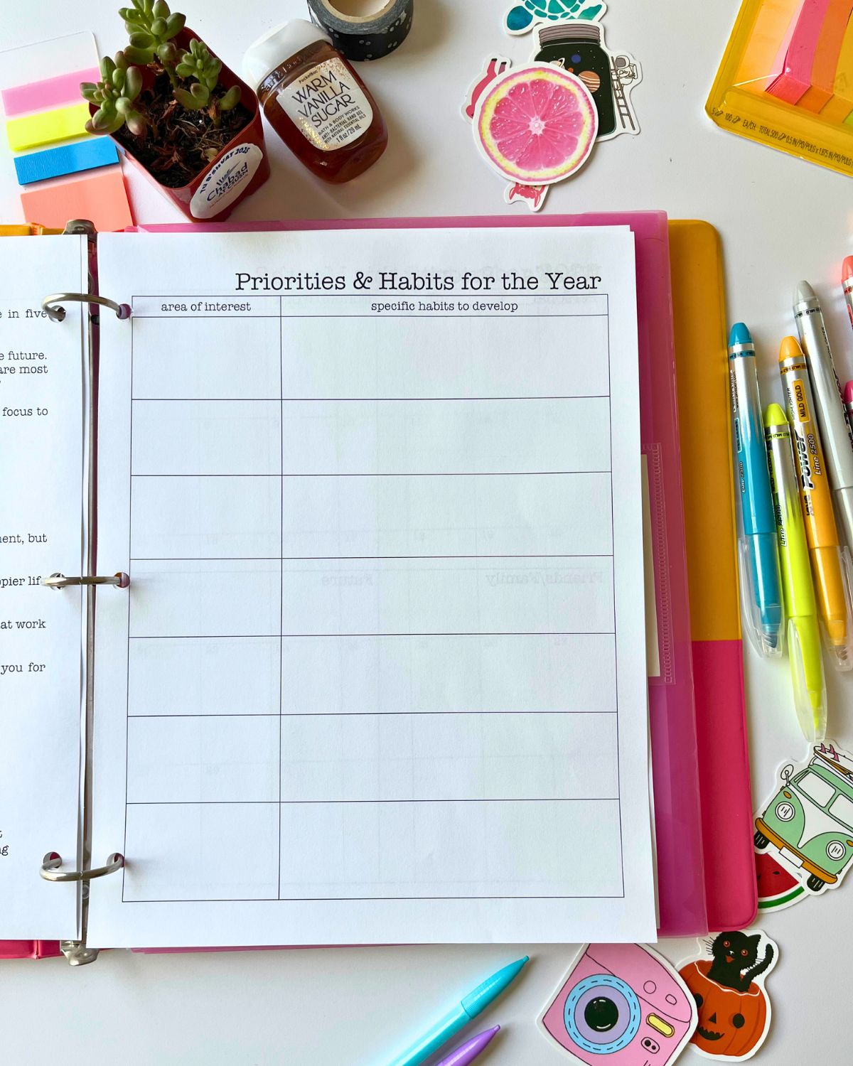 student planner open to priority page with planner accessories on table nearby.