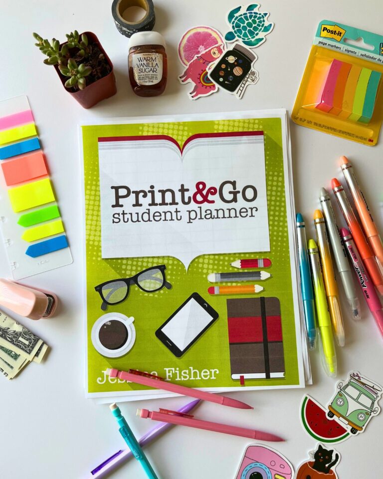 printed cover of student planner on table with planner accessories.