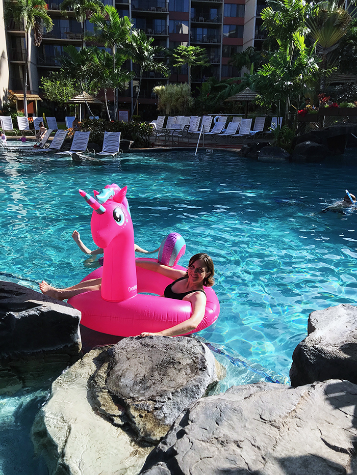 mom in pink unicorn floatie in pool
