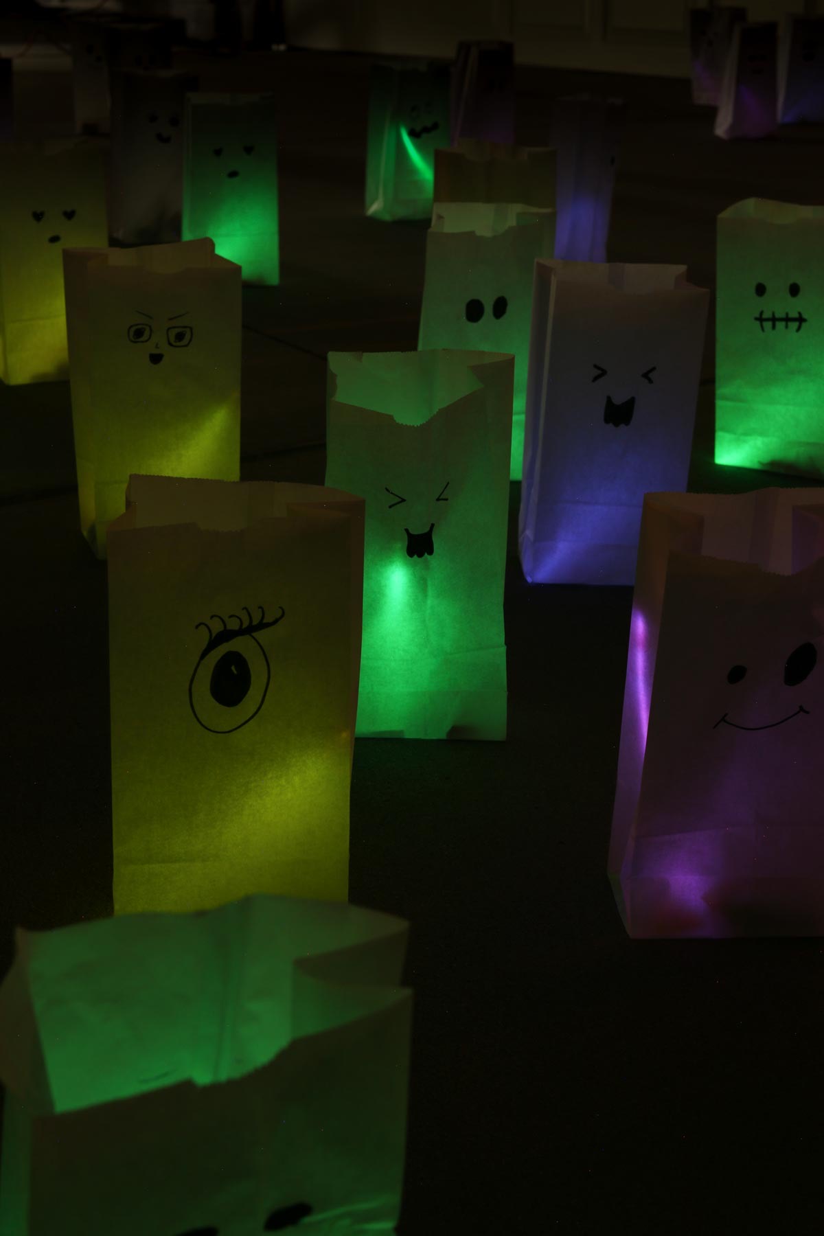 glowing ghost halloween treat bags in the night.