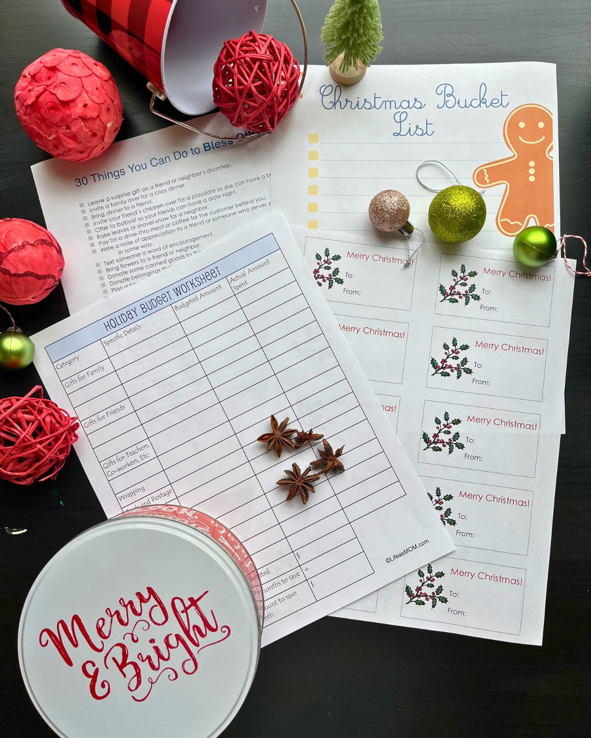 array of christmas printables with holiday decor on table.