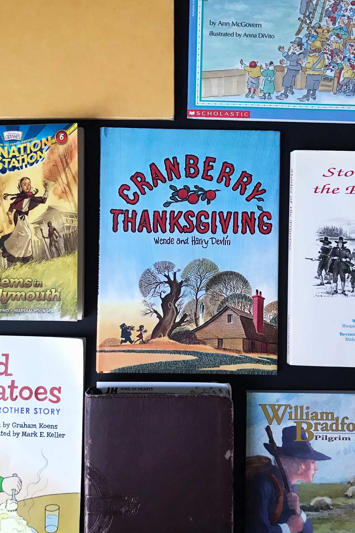 an array of thanksgiving read alouds and picture books laid out on a black table top.