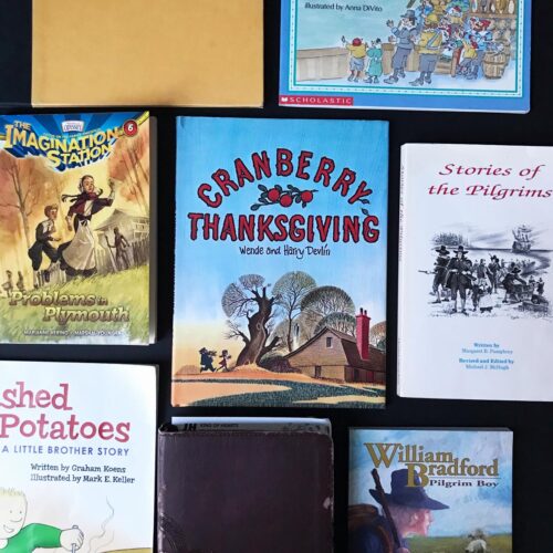 thanksgiving read alouds laid out on a black table top, focusing on Cranberry Thanksgiving book.