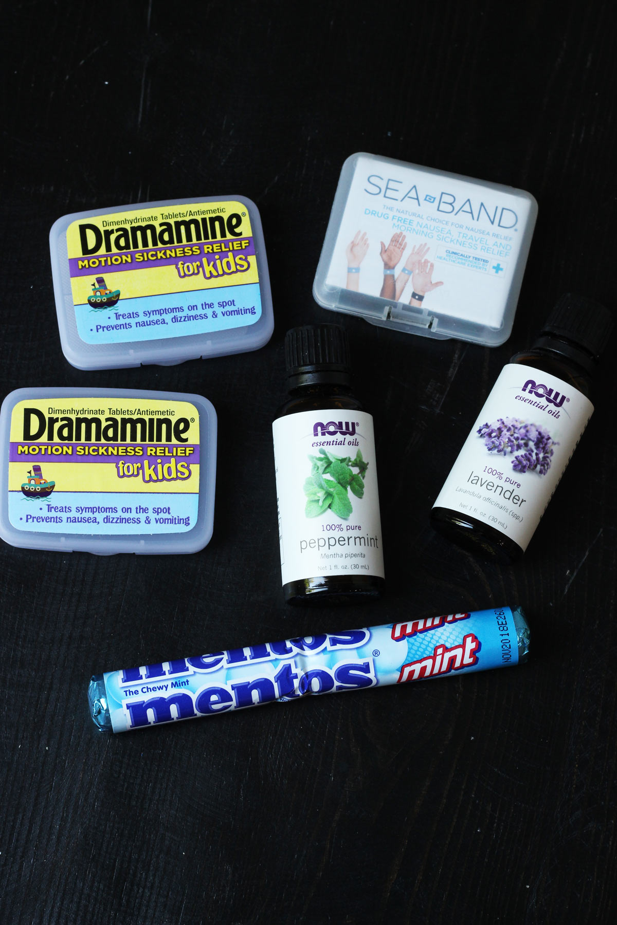 sea bands, essential oils, and mints laid out on a table.