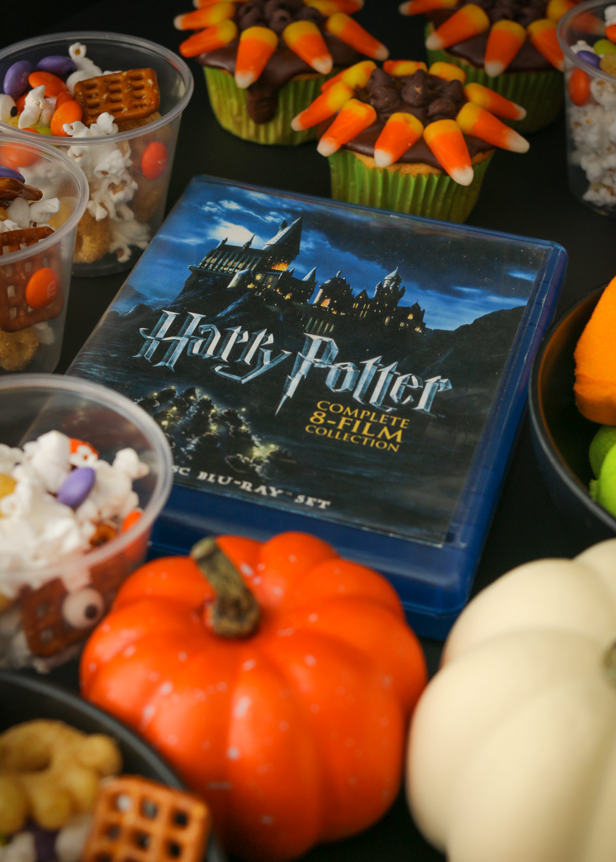 harry potter boxed set, surrounded by pumpkins and snacks.