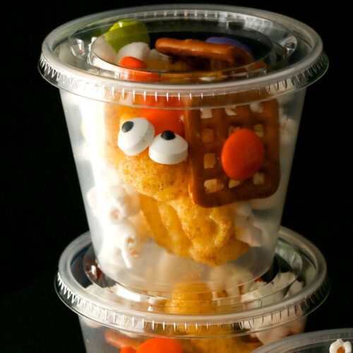 close up of snack mix in cup with lid.