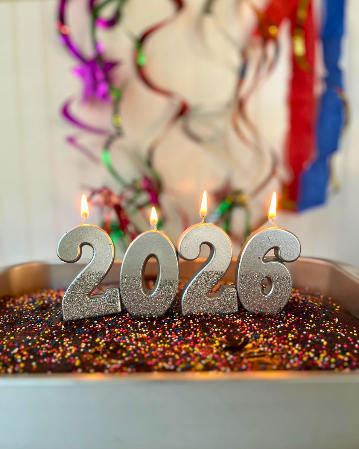 new years cake for kids with lit number candles.