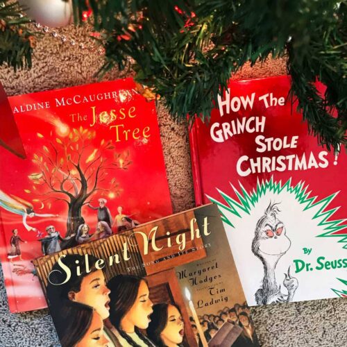 three christmas story books under the tree.