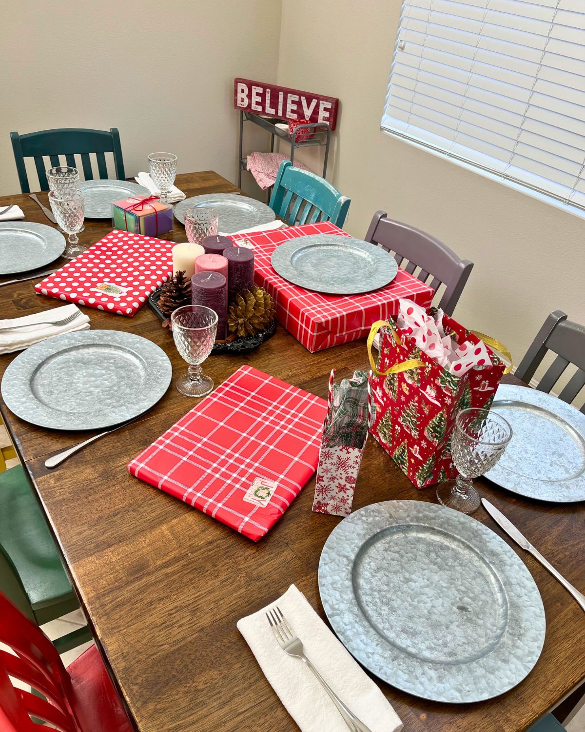 table set with wrapped presents and advent candles.