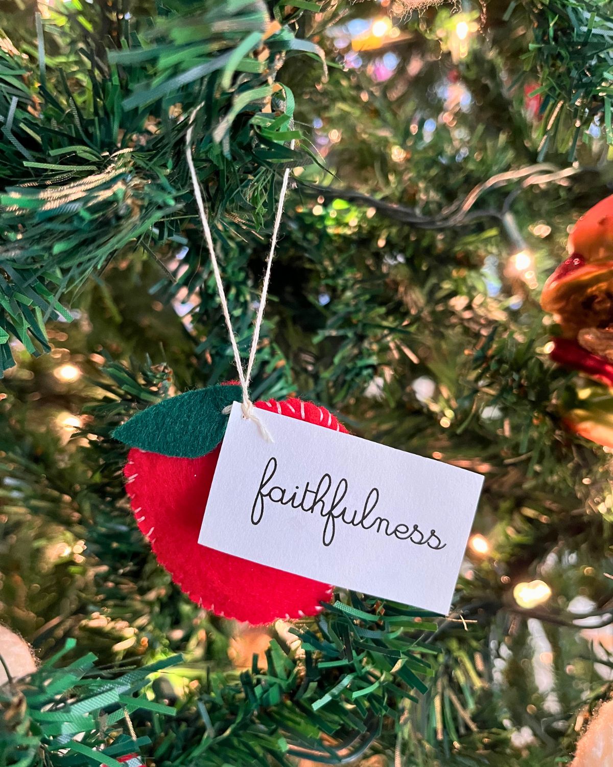 apple ornament with faithfulness tag on tree.