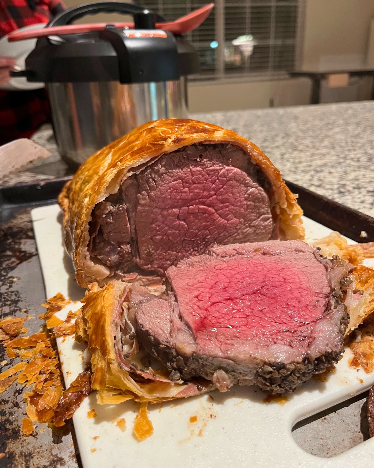 cut side of beef wellington on cutting board.
