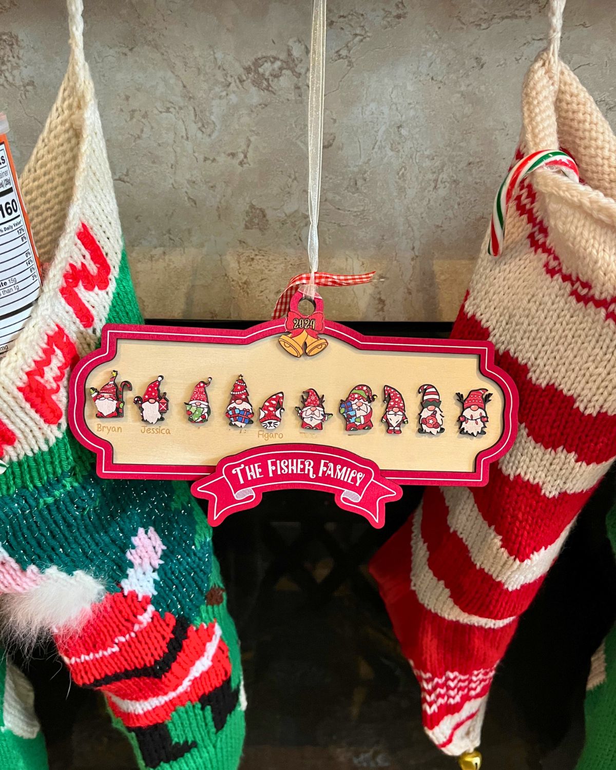 Fisher Family christmas ornament of 2024 with names blocked out.