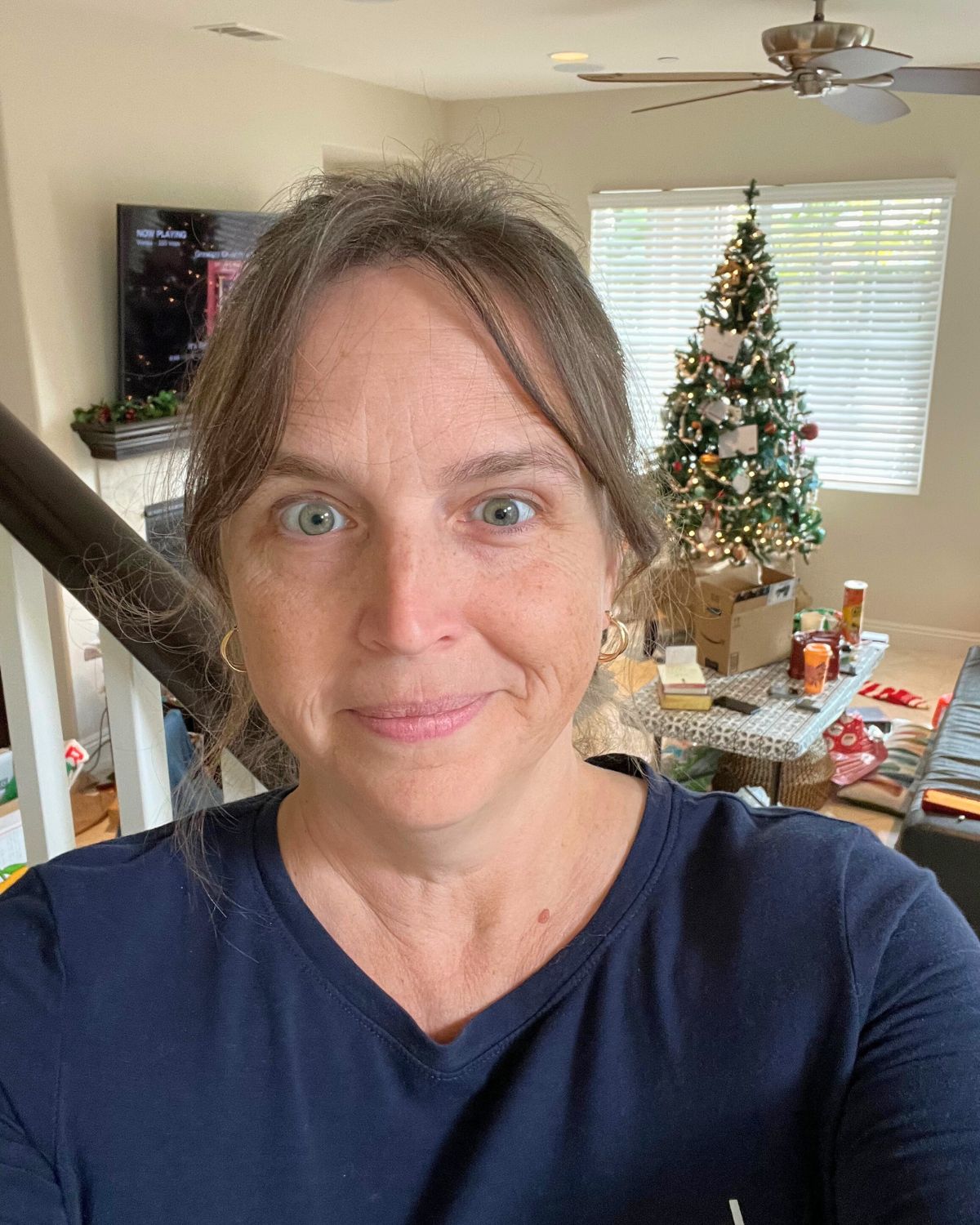 selfie of jessica on stairs with tree in background.