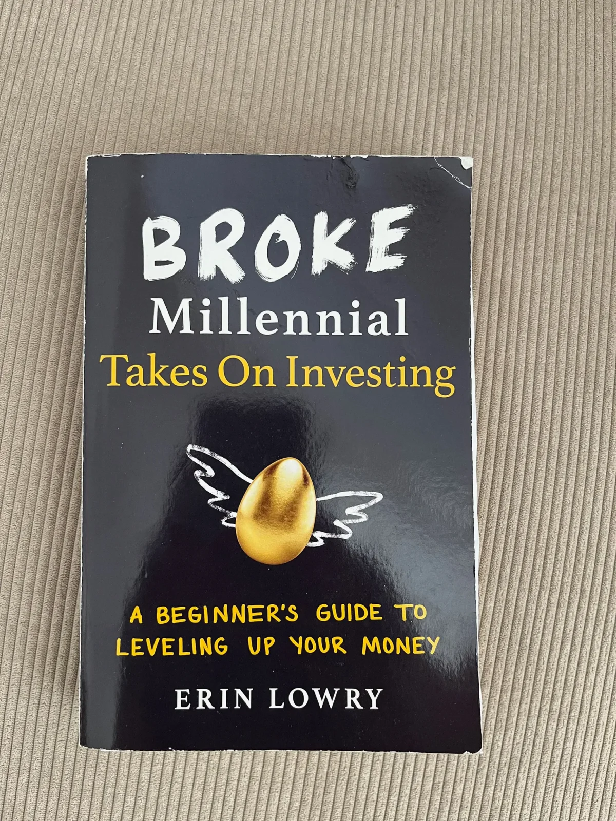 paperback copy of broke millennial takes on investing.