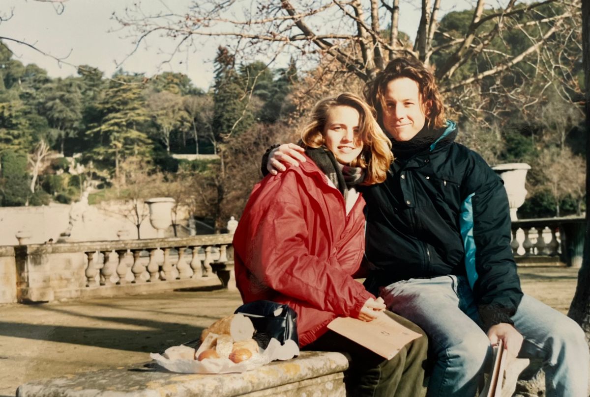 jessica and bryan sitting on a bench in nimes with a picnic.