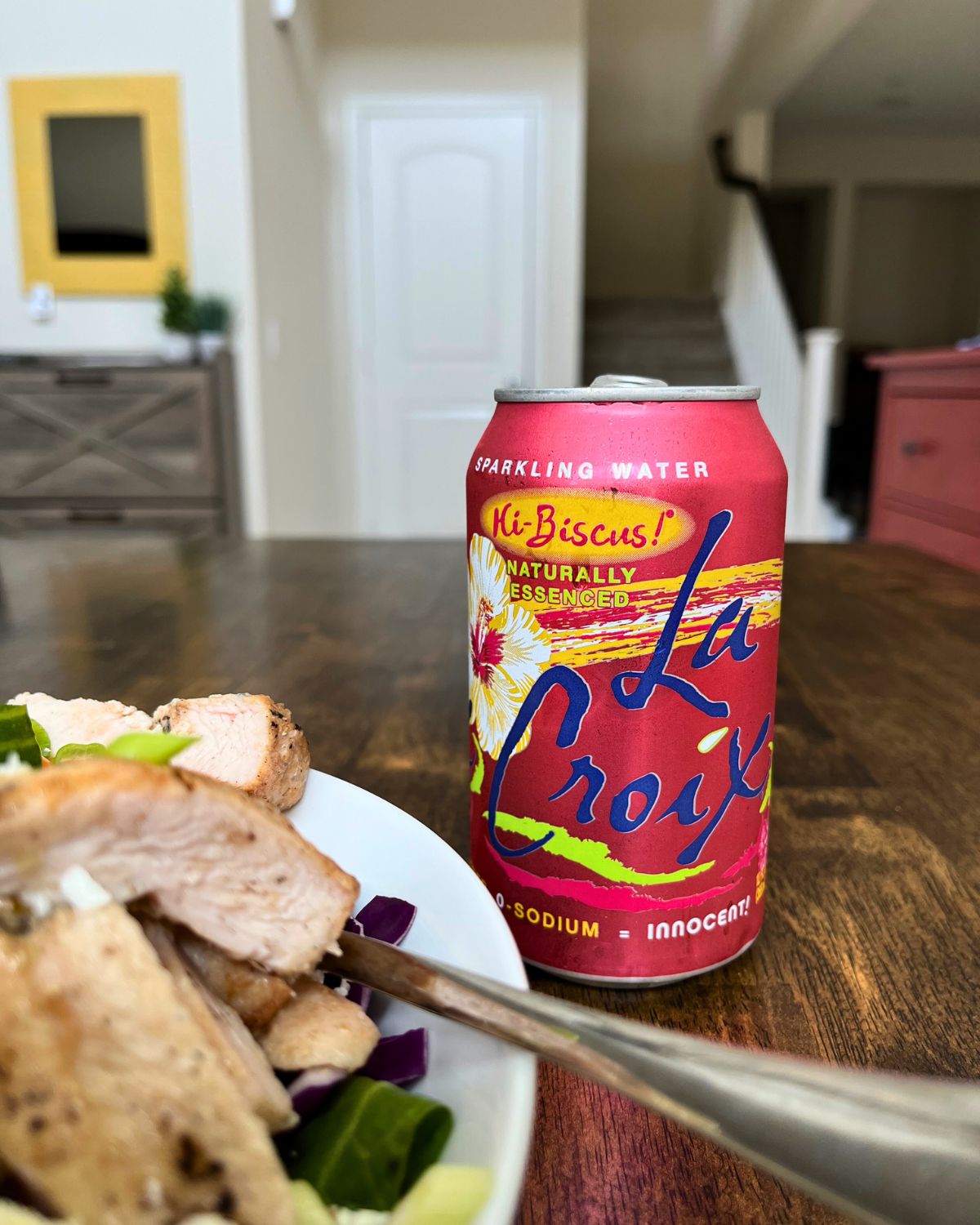 can of la croix on table with salad.