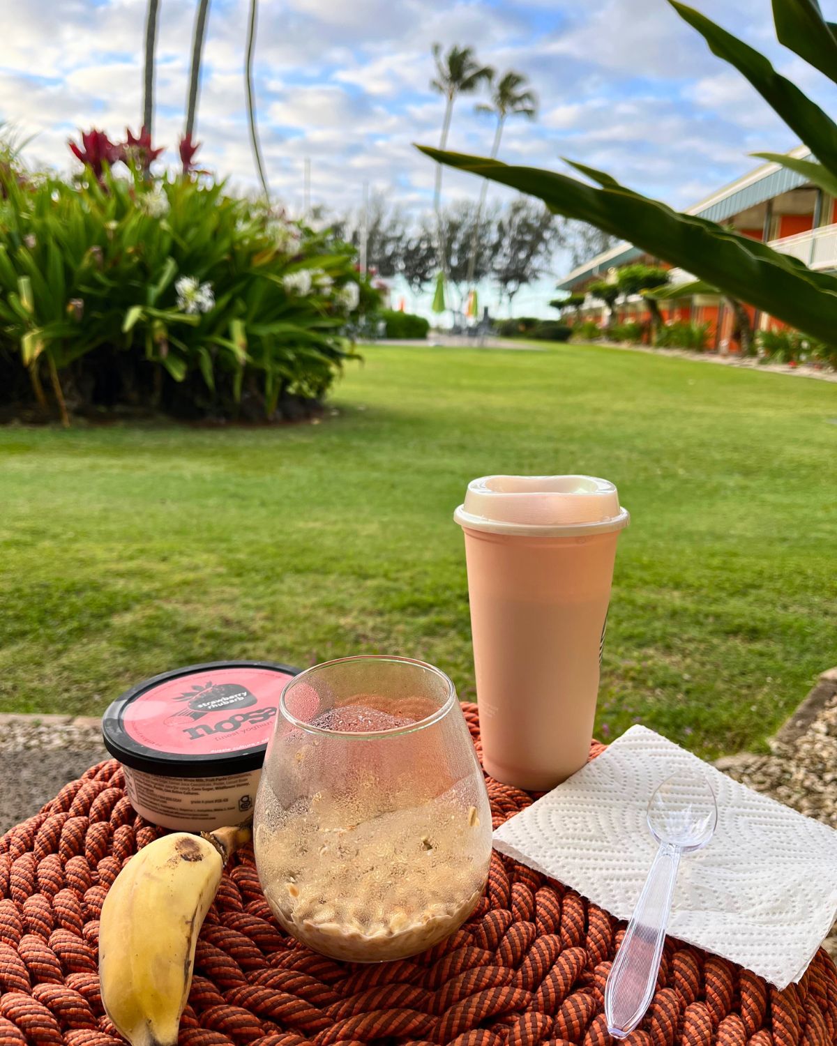breakfast on an orange table on the lanai, facing the beach.