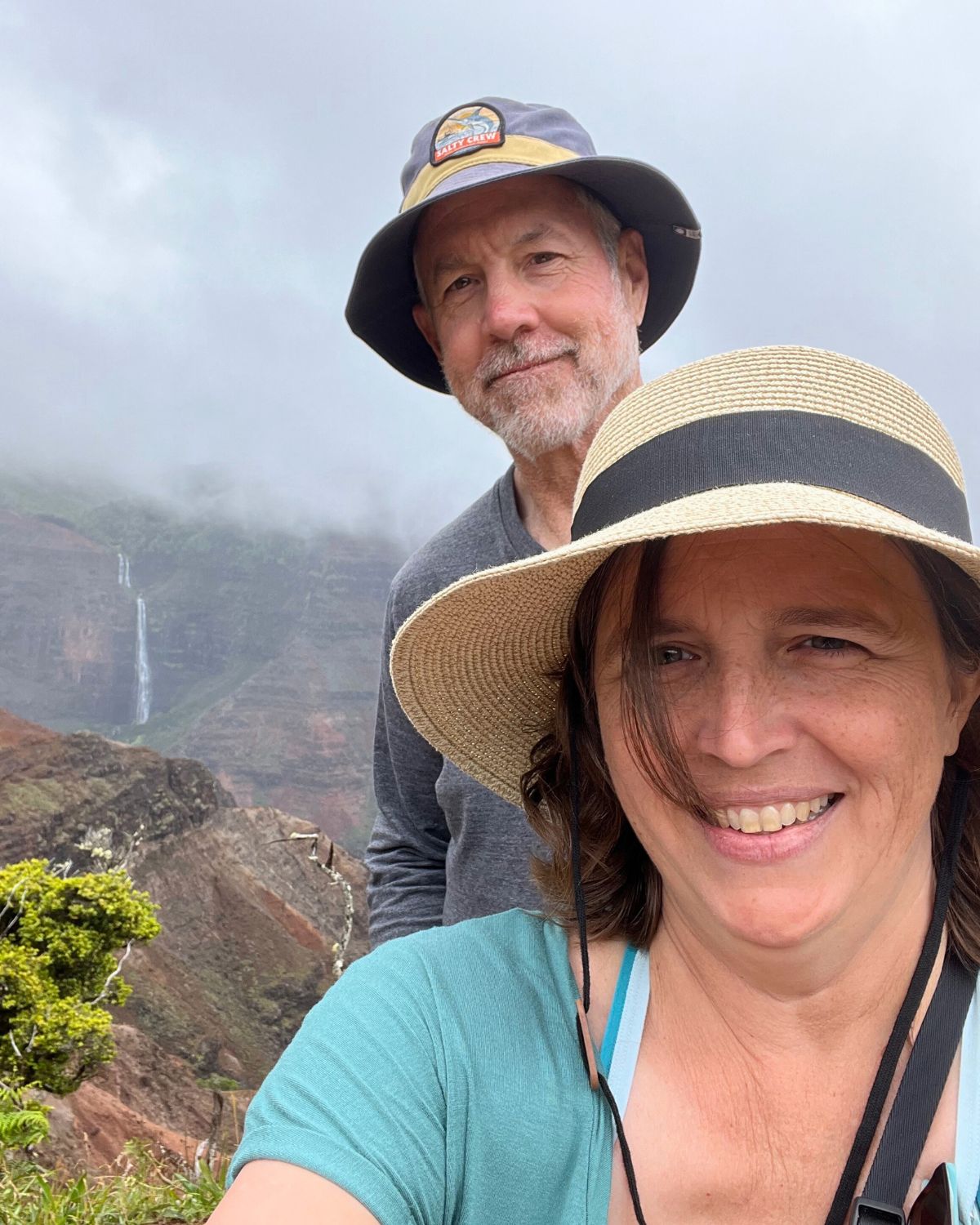 bryan and jessica in front of waterfall in kauai.