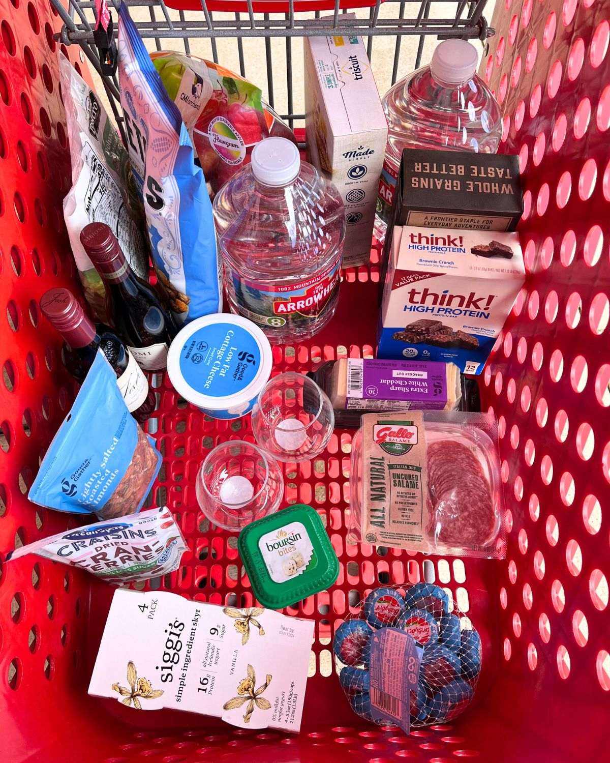 target cart full of snacks and half bottles of wine.