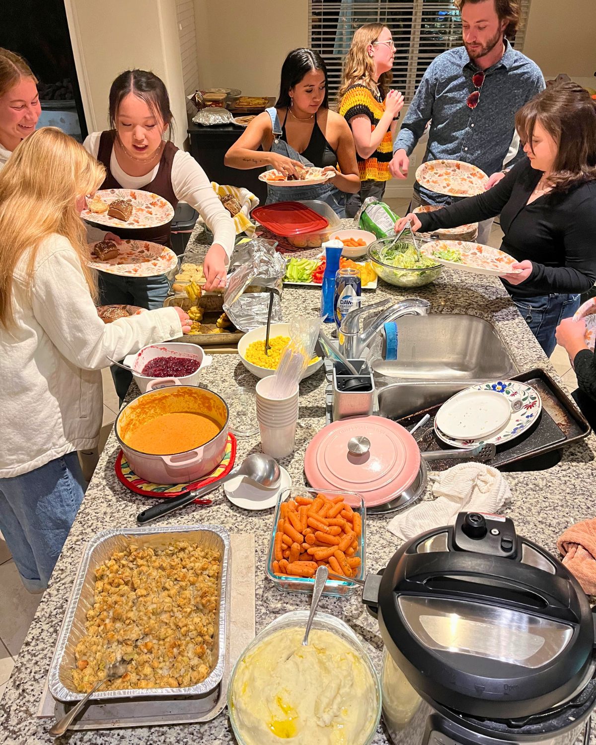 kids dishing up food for friendsgiving.