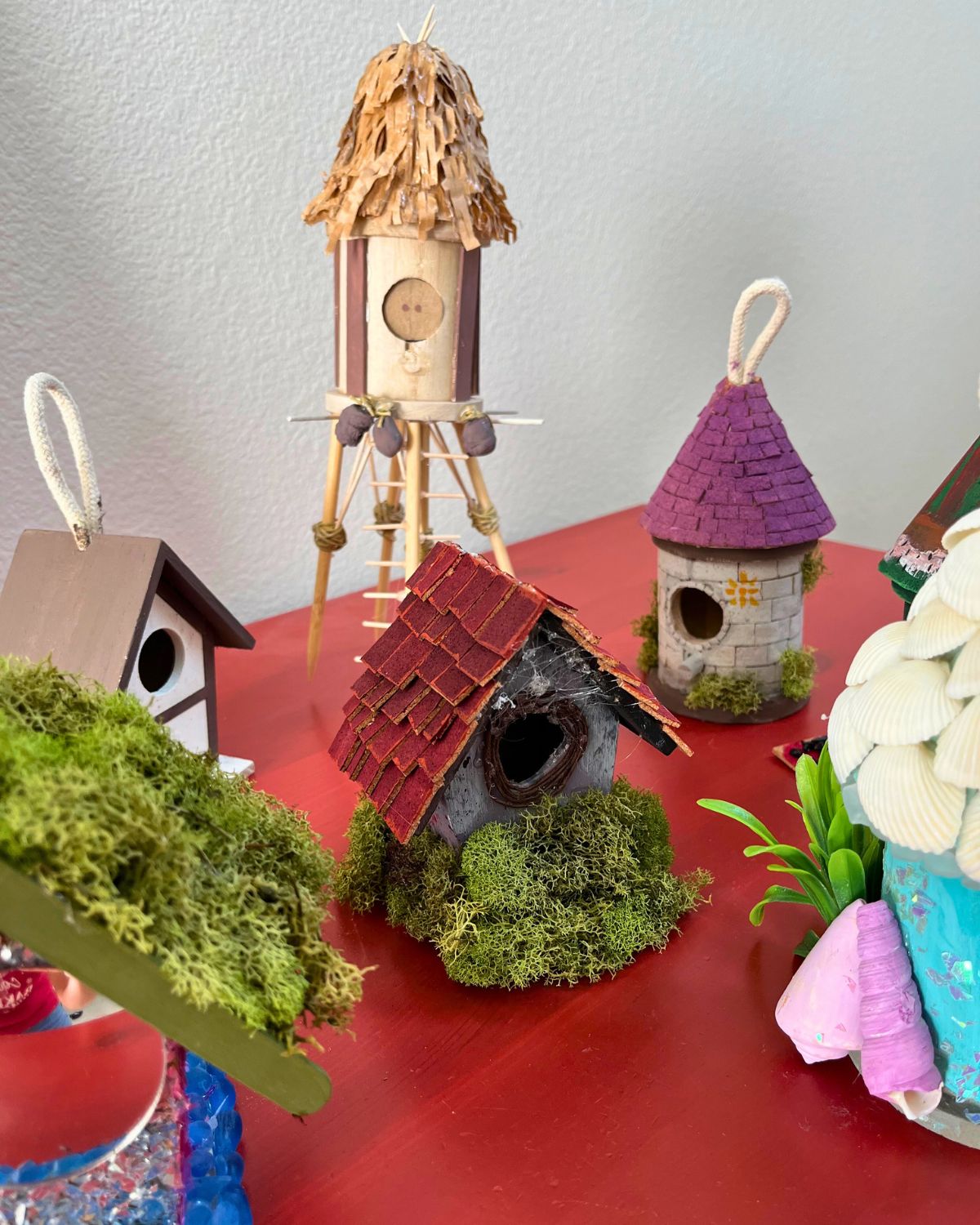 christmas eve birdhouses on red dresser.