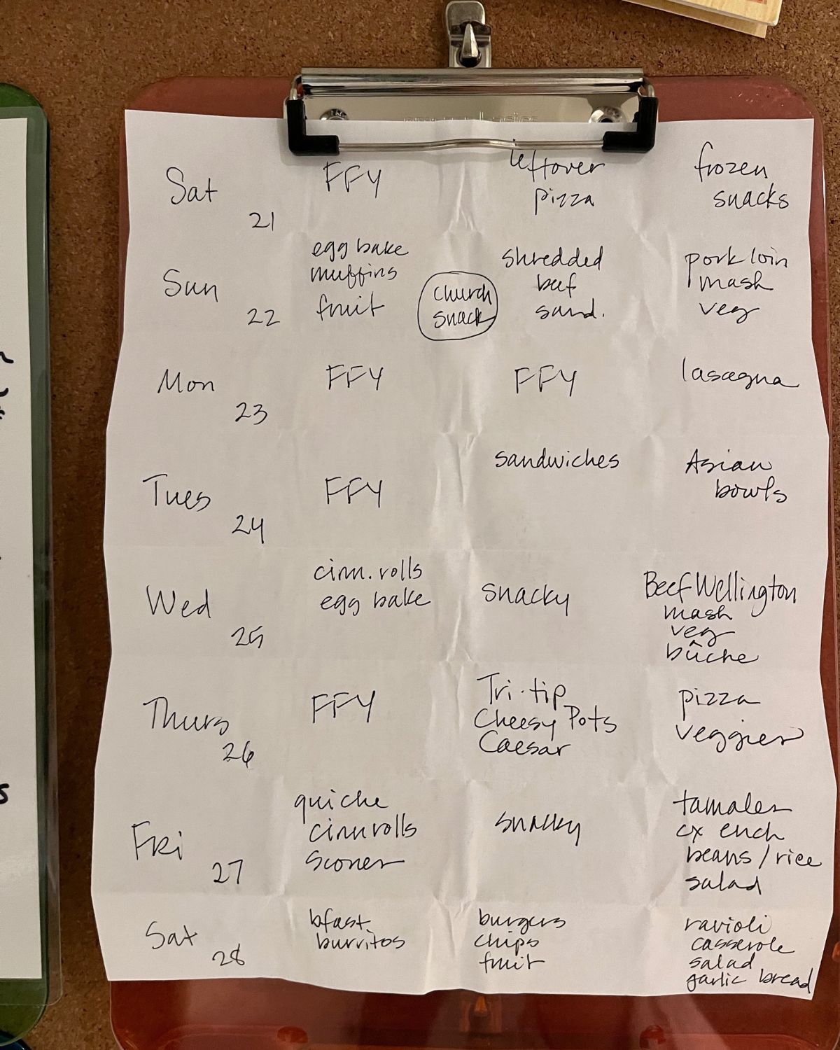handwritten meal plans on folded white paper.