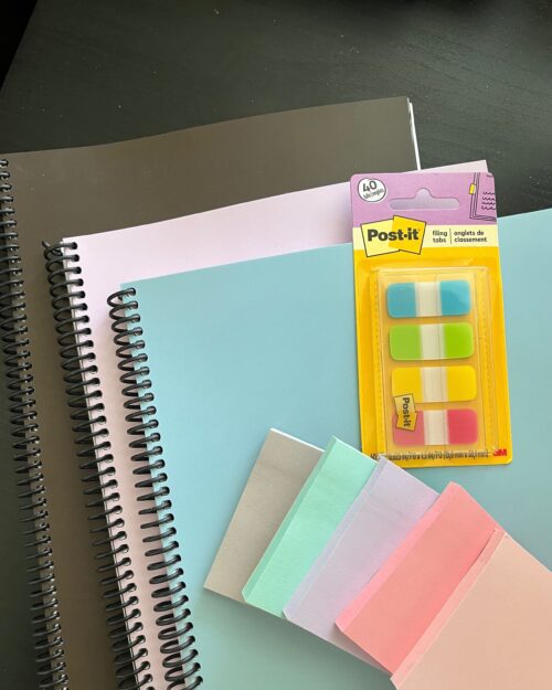 three printed planners with post-its.