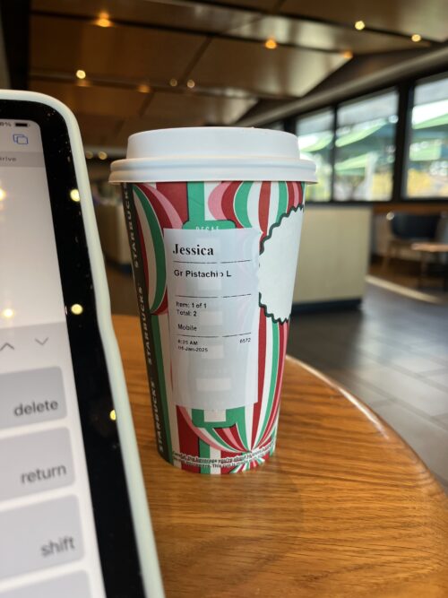 Starbucks holiday cup on table.