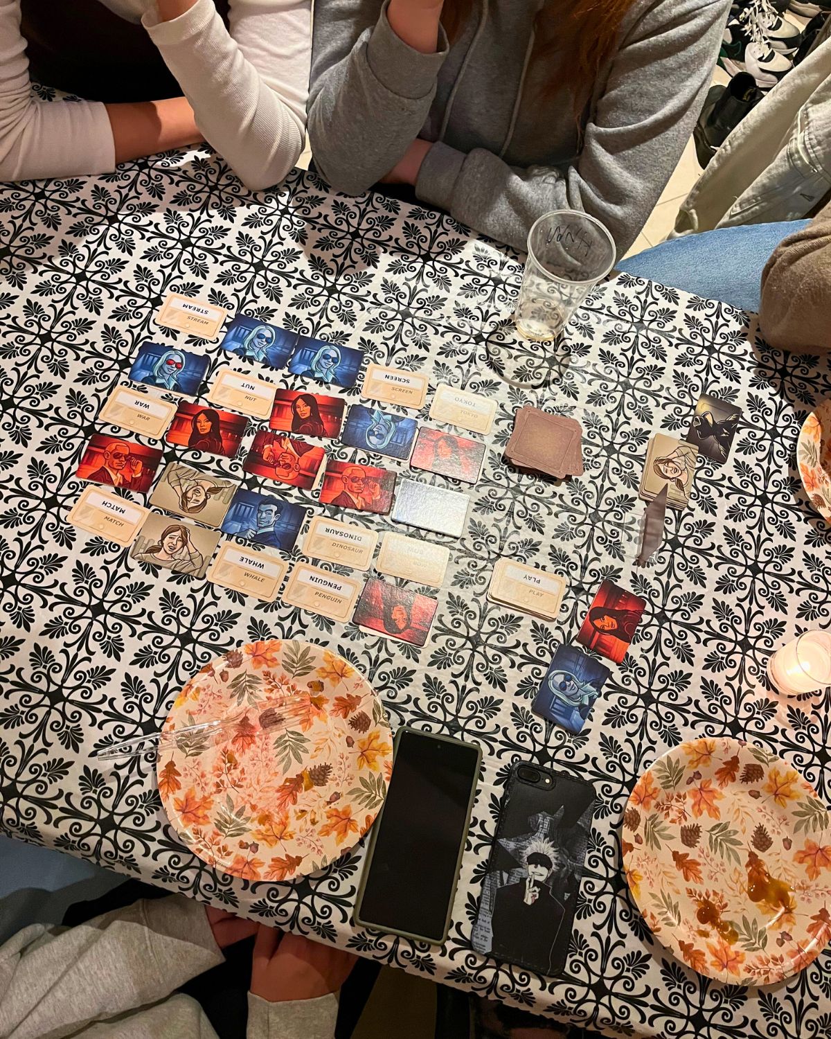 game night table with code names cards and dinner plates.