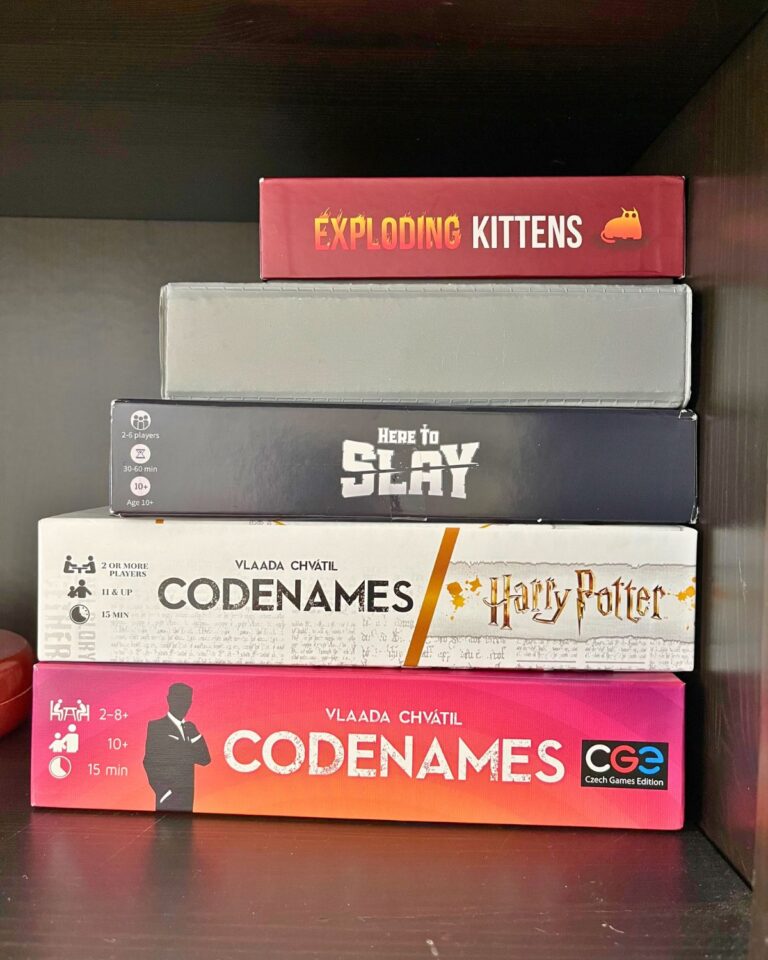 stack of games on a black shelf.