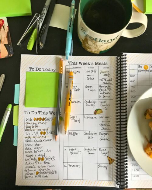 open planner with fresh post-it note for a to-do list.