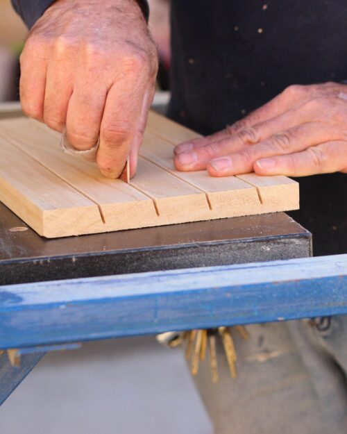 sanding the channels on the card holders.