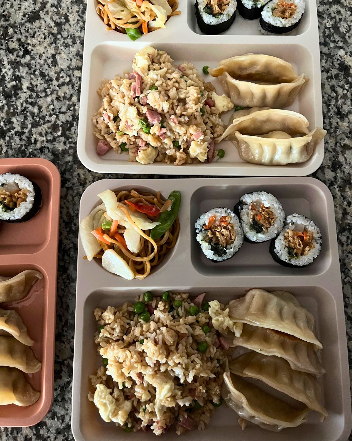 array of bento box lunches with asian food.